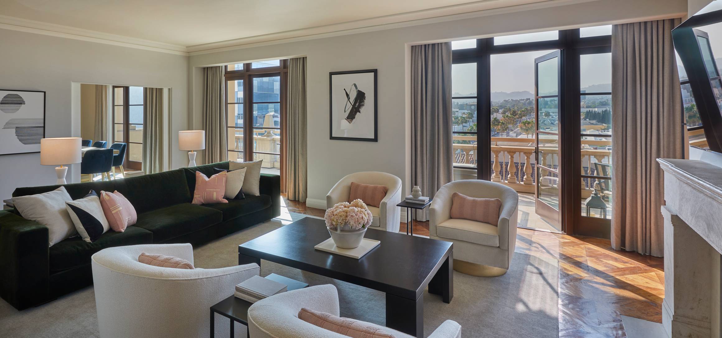 A refined living space with plush seating, soft lighting, and floor-to-ceiling windows opening to a private terrace.