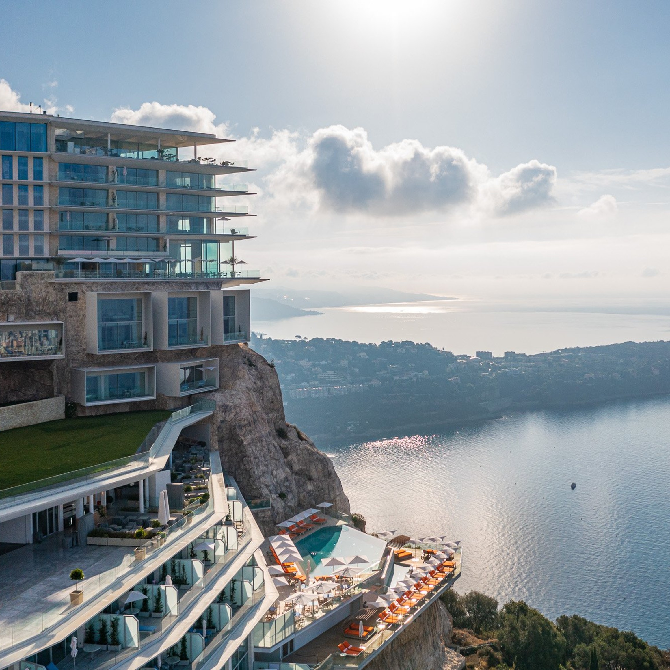 A breathtaking clifftop hotel overlooking the Mediterranean, featuring modern architecture, infinity pools, and panoramic views of the coastline.